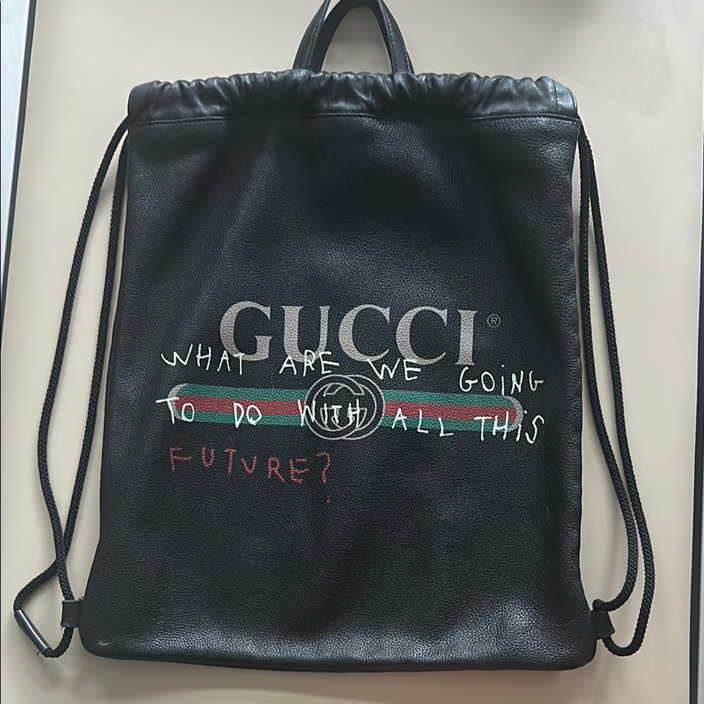 Gucci Black Leather Drawstring Backpack with Graphic Text